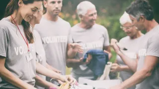 Volunteers sorting donations outdoors.