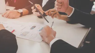 Business professionals looking over documents