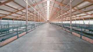 Long interior shot of a large empty industrial building.