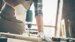 Man drilling board