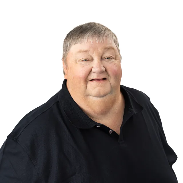 Portrait of a smiling, fair-skinned person wearing a black shirt.