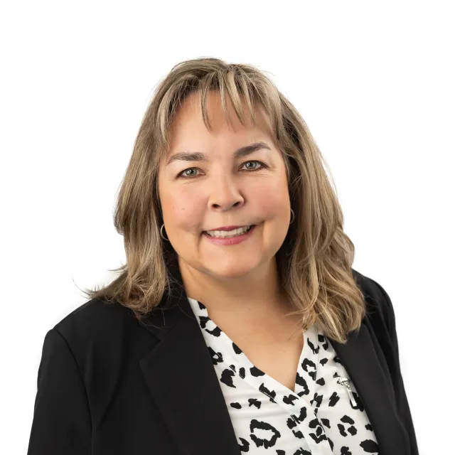 Smiling woman in a black blazer.