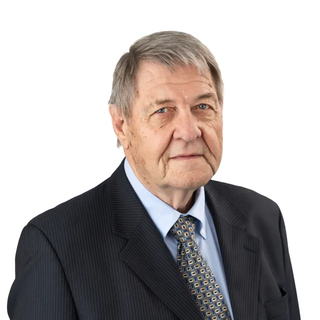 Photograph of an older man in a suit and tie.