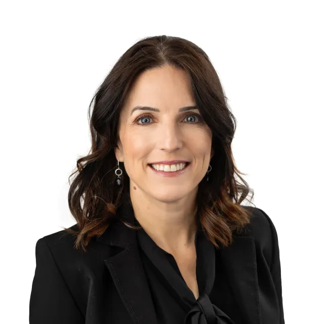 Headshot of a smiling woman wearing a black blazer and blouse.